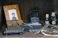 Retro stamp, vintage photo and medicine bottles on the old doctor desk. Glasses, tools and a photograph of a woman in a vintage Royalty Free Stock Photo