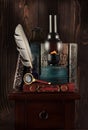 Retro still life with old books, kerosene lamp, antique inkwell with a feather and a hand magnifier Royalty Free Stock Photo