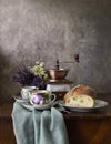 Retro still life poster breakfast. Vintage coffee grinder cups, silver spoon, homemade bread bakery. Dark light, wooden Royalty Free Stock Photo