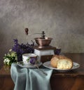 Retro still life poster breakfast. Vintage coffee grinder cups, silver spoon, homemade bread bakery. Dark light, wooden