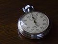 Retro stopwatch is on a wooden table