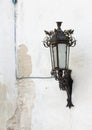 Retro street lantern on peeling plaster wall Royalty Free Stock Photo