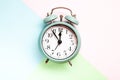 Retro style alarm clock over the pastel background Royalty Free Stock Photo