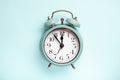 Retro style alarm clock over the blue background Royalty Free Stock Photo