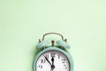 Retro style alarm clock over the mint green background Royalty Free Stock Photo