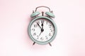 Retro style alarm clock over the pink background Royalty Free Stock Photo