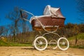 Retro style baby carriage outdoors on sunny day Royalty Free Stock Photo