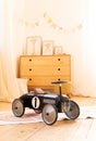 Retro style children`s racing car in a children room. Black vintage model of race car for boy. interior children bedroom Royalty Free Stock Photo