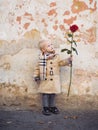 Retro style. happy birthday. wedding. little boy in vintage coat. Beauty. small kid has red rose. happy childhood. love