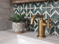 Retro style metal tap and sink in modern bathroom interior with soap bottle and green ceramic tiles wall in the Royalty Free Stock Photo