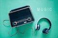 Retro style old  boombox radio from 1950s, 1960s and headphones on green pastel paper background .Vintage tone instagram style Royalty Free Stock Photo