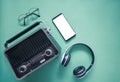 Retro style old boombox radio from the 1950s, 1960s, vintage glasses, blank screen Mockup smartphone, Electronic Headset object on Royalty Free Stock Photo