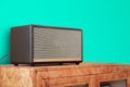 Retro style old  boombox radio from 1950s, 1960s  on wooden furniture, green pastel wall background and Vintage tone instagram Royalty Free Stock Photo