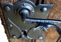 Iron retro classical door handle and lock on old wooden door Royalty Free Stock Photo