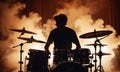 Retro style photo of drummer silhouette surrounded by smoke in concert