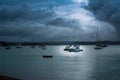 Retro style photo of pleasure and fishing boats anchored in a small harbour on a stormy day Royalty Free Stock Photo