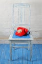 Retro style - Red vintage phone, old chair Royalty Free Stock Photo