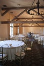 Wide view on banquet ball room in vintage style with lot of tables, chairs and theater scene