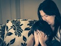 Retro style of sad little boy being hugged by his mother at home. Royalty Free Stock Photo