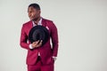 Retro style well dressed African american business man model in red suit and black hat in studio on white background Royalty Free Stock Photo