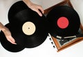 Retro style, woman hands holding vinyl record, vinyl player Royalty Free Stock Photo