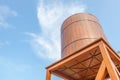 Retro style wooden water tower over the blue sky background. Royalty Free Stock Photo