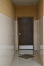 Door at the end of a tiled hallway and linoleum floor retro style Royalty Free Stock Photo