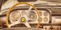 Retro styled iamge of the interior of a classic Ferrari sports car with wooden steering wheel in Essen, Germany