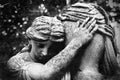 Retro styled image of an ancient statue of desperate woman on tomb as a symbol of death, pain and sadness. Selective focus