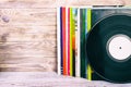 Retro styled image of a collection of old vinyl record lp`s with sleeves on a wooden background with Copy space toned Royalty Free Stock Photo