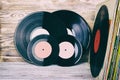 Retro styled image of a collection of old vinyl record lp`s with sleeves on a wooden background with Copy space top view toned Royalty Free Stock Photo