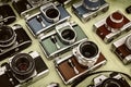 Retro styled image of colorful photo cameras on a flee market