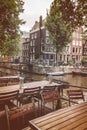 Retro styled image of empty restaurant tables in Amsterdam