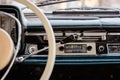 Retro styled image of an old car radio and dashboard inside a classic car Royalty Free Stock Photo