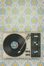 Old record player on top of flower wallpaper Royalty Free Stock Photo