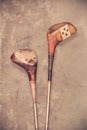 Retro styled image of two weathered ancient golf clubs Royalty Free Stock Photo