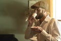 Retro styled man tasting a coffee in a vintage environment Royalty Free Stock Photo