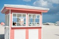 Retro styled pink and white timber kiosk on beach at Miami with