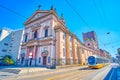 The retro styled tram rides at the monumental Basilica of St.Antonio of Padua in Milan, Italy