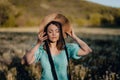 Retro styled woman on fluffy dandelions field, amazing fantasy portrait. Romantic elegant lady with straw hat on nature