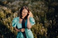 Retro styled woman on fluffy dandelions field, amazing fantasy portrait. Romantic elegant lady with straw hat on nature Royalty Free Stock Photo