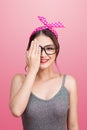 Retro styled young asian woman covers her eyes with one hand. Royalty Free Stock Photo