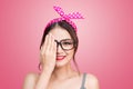 Retro styled young asian woman covers her eyes with one hand. Royalty Free Stock Photo