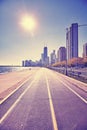 Retro stylized Chicago waterfront against sun with lens flare