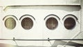 Retro stylized close up picture of an old ship portholes Royalty Free Stock Photo