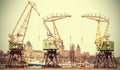 Retro stylized picture of cranes in Szczecin City.