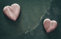 Retro stylized two wooden hearts on cracked stone background. Royalty Free Stock Photo
