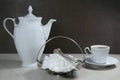 Sugar cubes in metal vintage sugar  bowl with sugar tongs and cups with coffee or tea pot Royalty Free Stock Photo