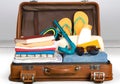 Retro suitcase with travel objects on grey Royalty Free Stock Photo