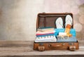 Retro suitcase with travel objects on wooden Royalty Free Stock Photo